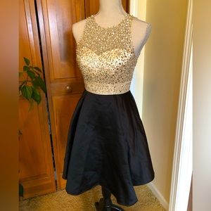 Beautiful gold black jeweled party dress never worn.